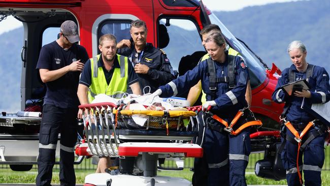 The QG Air 510 Rescue emergency services helicopter transports a 36-year-old spearfisherman to Cairns Hospital, after he was bitten multiple times by a 4.5 metre saltwater crocodile off Archer Point. Picture: Brendan Radke