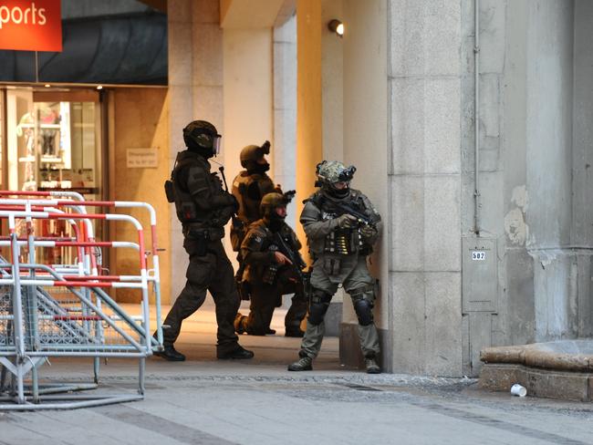 Police secure the area of a subway station Karlsplatz (Stachus) near a shopping mall following the shooting in Munich.