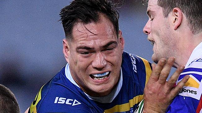 Tepai Moeroa of the Eels is tackled by Jack Cogger (left) and Lachlan Fitzgibbon of the Knights during the Round 13 NRL match between the Parramatta Eels and the Newcastle Knights at ANZ Stadium in Sydney, Saturday, June 2, 2018. (AAP Image/Dan Himbrechts) NO ARCHIVING, EDITORIAL USE ONLY