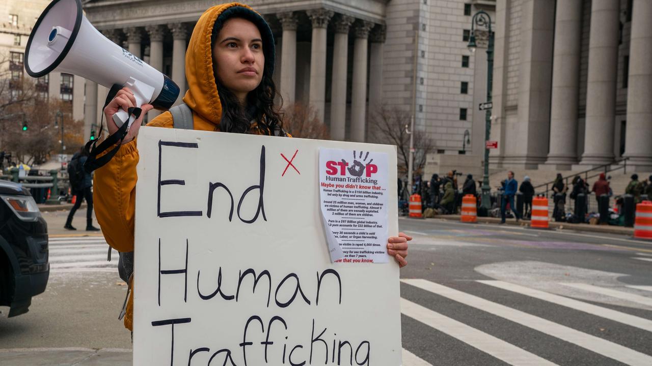 People gather to protest human trafficking at the Thurgood Marshall United States Courthouse where the trial of Ghislaine Maxwell is being held in New York City.