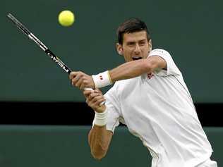 STREAK CONTINUES: Novak Djokovic of Serbia returns to Frenchman Adrian Mannarino in the second round at Wimbledon. Picture: Ben Curtis