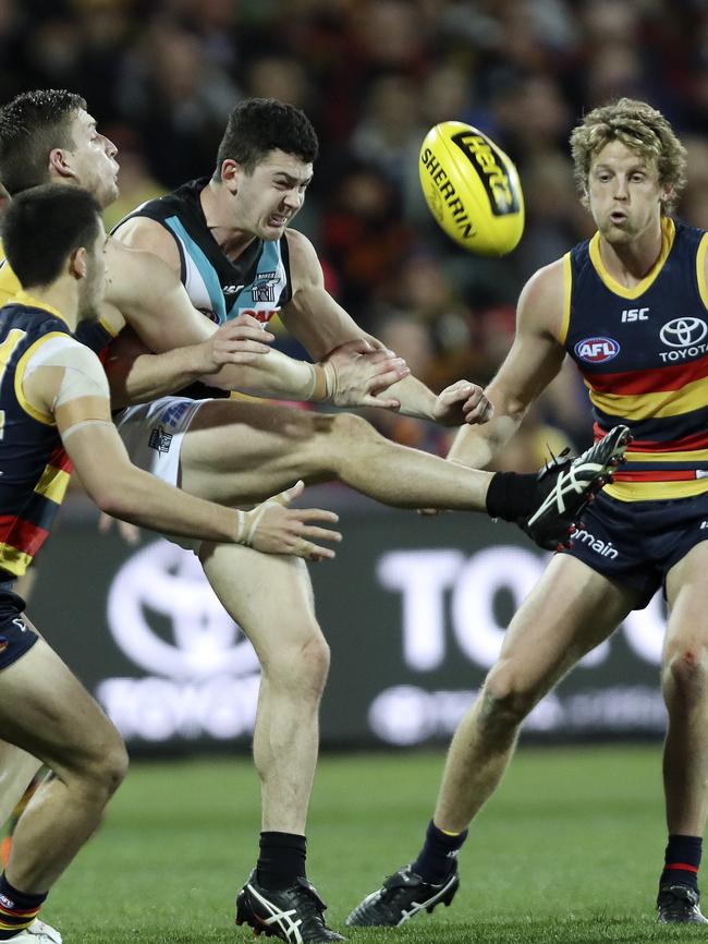 Darcy Byrne-Jones gets his kick away under pressure from Rory Sloane. Picture: SARAH REED