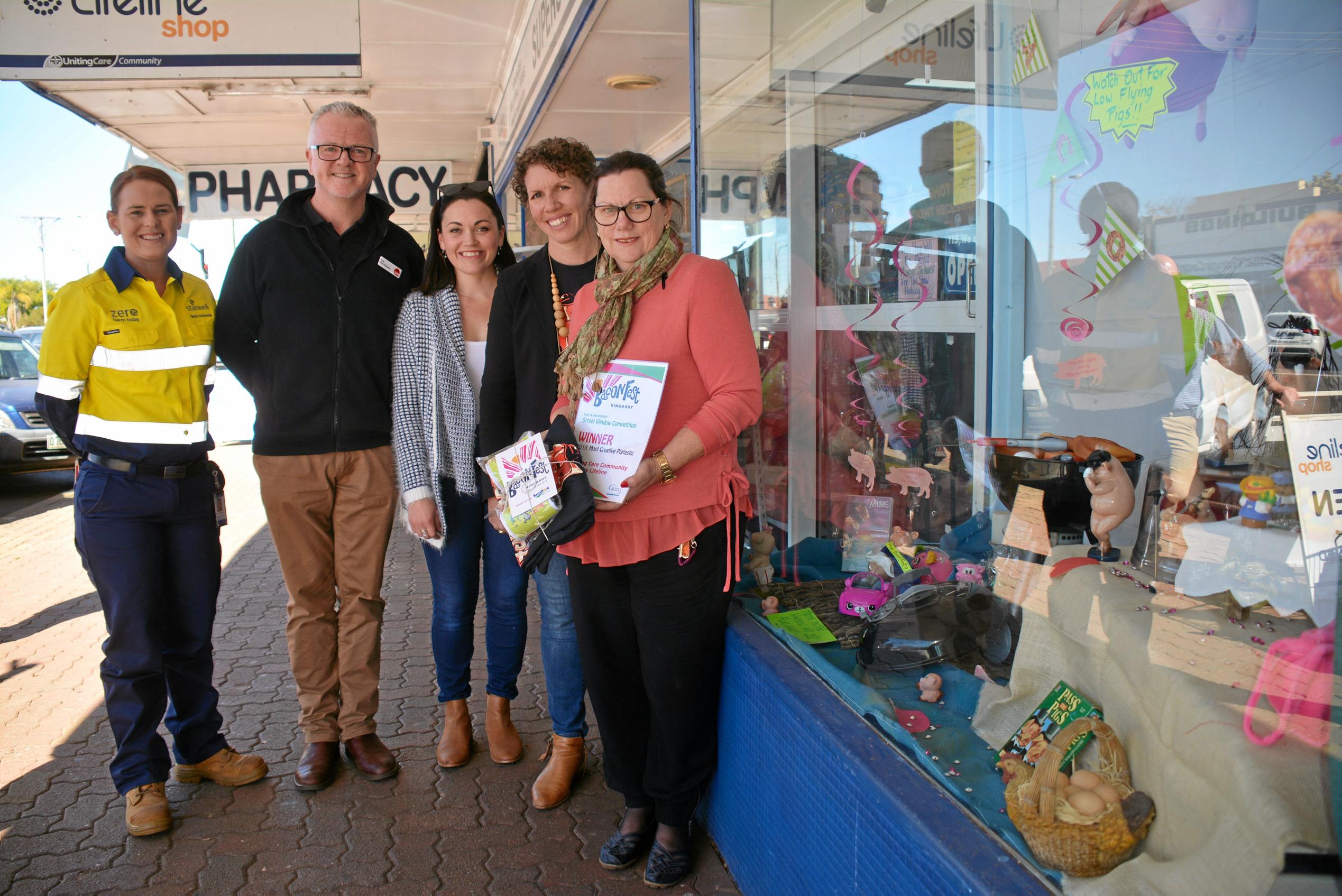 WINNER: BaconFest committee members Kirstie Schumacher, Rob Fitz-Herbert, Felicity Cavill and Kath Stevens with Lifeline store manager Debbie Cox in front of the most creative pigtastic window. Picture: Jessica McGrath