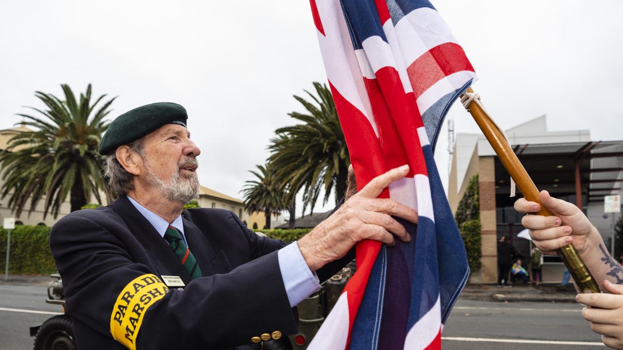 Parade marshall Ken Barclay checks a flag before the Anzac Day morning march, Monday, April 25, 2022. Picture: Kevin Farmer