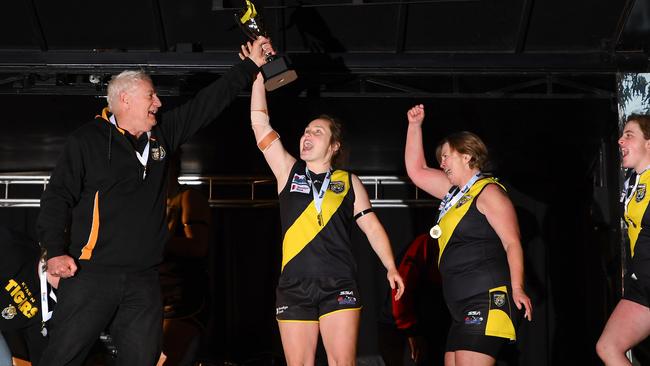 Kyneton coach Phil Hawkes and captain Teagan Ainslie hold aloft the premiership cup. Picture: Josh Chadwick
