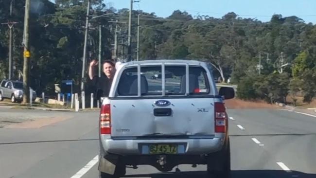 Bianca Sams throws a nail at the vehicle of Clint Pollard driving behind.