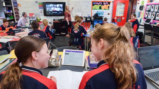 Walkerville Primary students Ruby and Sophia, with teacher Kristan Gilbert, at back. Picture: AAP / Brenton Edwards