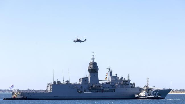 An MH-60R Seahawk helicopter conducts a fly past as HMAS Toowoomba returns to Fleet Base West after conducting a Regional Presence Deployment.