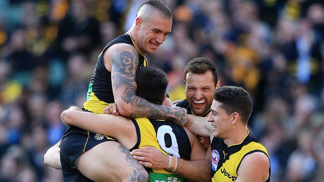 Martin mobs captain Trent Cotchin after his final-term goal. Picture: Mark Stewart