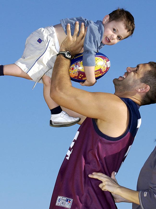 Former Lions star Chris Johnson holds then-young son Lachlan. Pic: Darren England