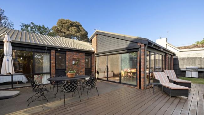 The outdoor entertaining area complete with a landscaped pool area.