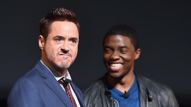 Robert Downey Jr. and Chadwick Boseman onstage during Marvel Studios fan event.