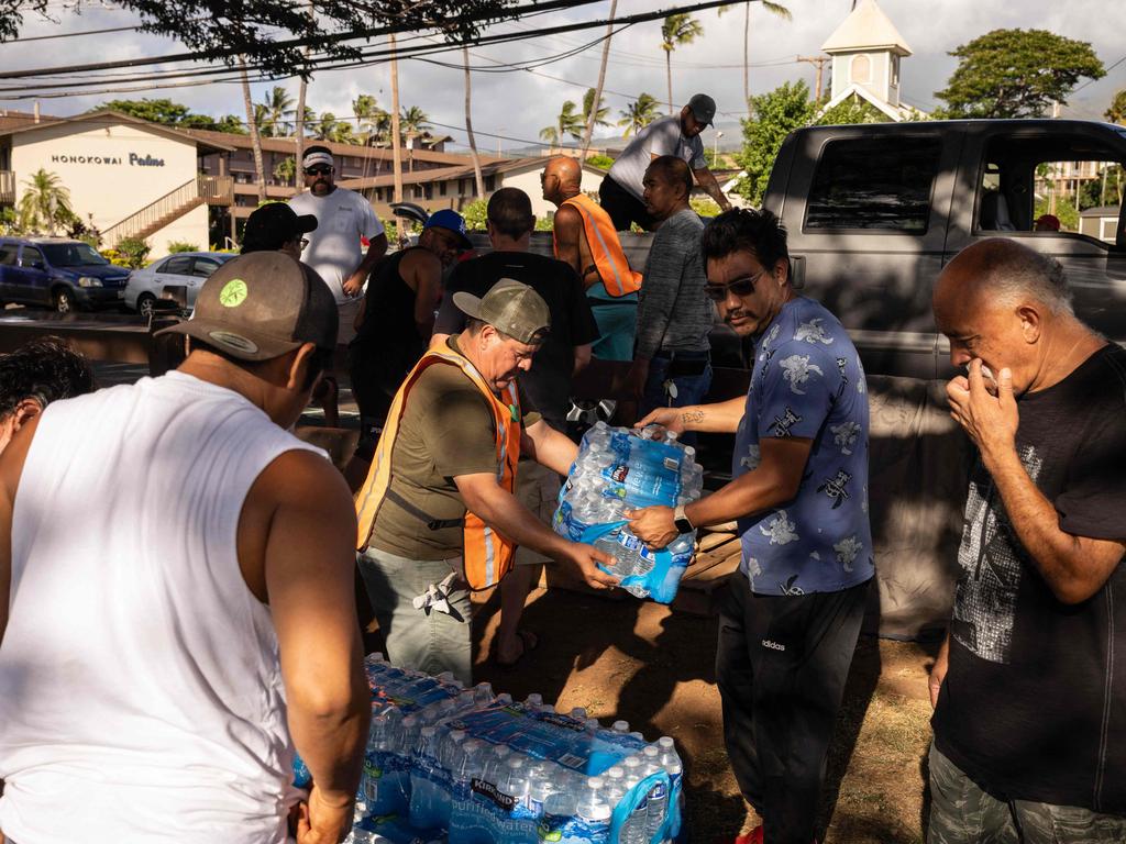 Volunteers unload donations at a distribution centre at Honokawai Beach Park in Napili-Honokowai, west of Maui, Hawaii. Picture: AFP