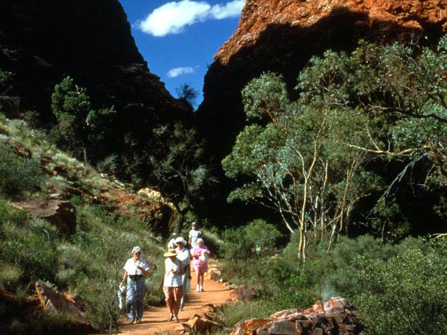 Tourists walk one of the tracks back from Simpson's Gap