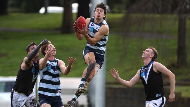 Nicholas Lucena of Old Geelong takes a mark against Mazenod in Premier C last season. Photo: Hamish Blair