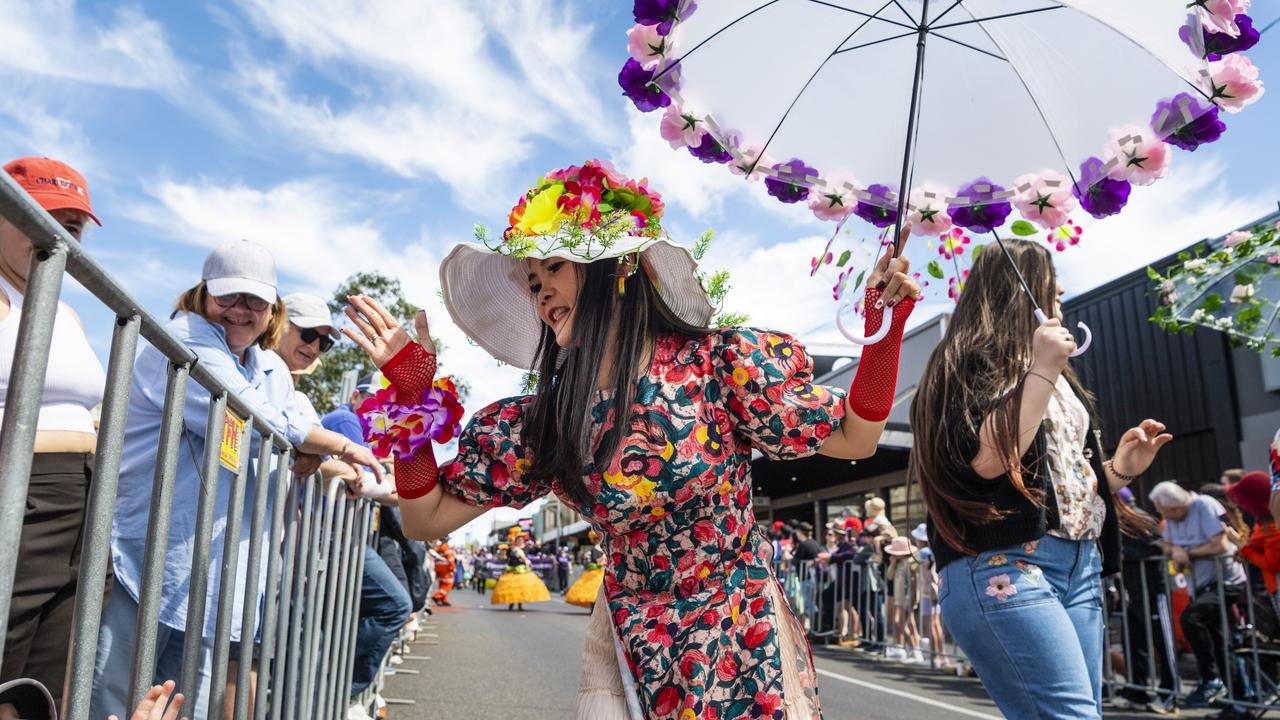 Uyen Vuong reacts to the crowd while walking with the Vietnamese community float during the Grand Central Floral Parade of Carnival of Flowers 2022, Saturday, September 17, 2022. Picture: Kevin Farmer