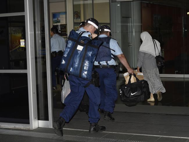 Police with evidence bags from the carpark where Leila Alavi was fatally stabbed. Picture: Gordon McComiskie