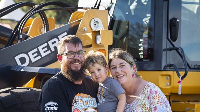 Mark and Penni Wick with son Banjo check out the earth moving equipment Toowoomba Royal Show, Thursday, April 18, 2024. Picture: Kevin Farmer