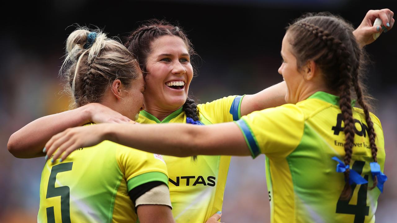 Emma Tonegato, Charlotte Caslick and Dominique Du Toit of Australia celebrate.