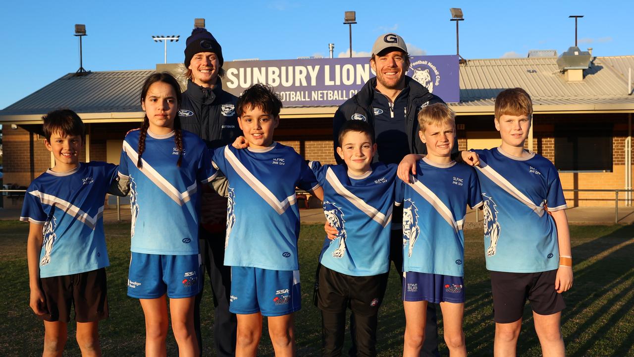 Zach Guthrie and Cam Guthrie with kids from Sunbury Lions Junior Football Club, where the Guthries started their football journey. Picture: Geelong Cats/Brad McGee