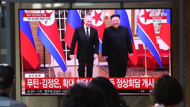 SEOUL, SOUTH KOREA - JUNE 19: People watch a television broadcast reporting a meeting between North Korean leader Kim Jong Un and Russian President Vladimir Putin at the Seoul railway station on June 19, 2024 in Seoul, South Korea. Russian President Vladimir Putin and North Korean leader Kim Jong-un began summit talks in Pyongyang, Russian news media reported, amid concerns about deepening military cooperation. (Photo by Chung Sung-Jun/Getty Images)