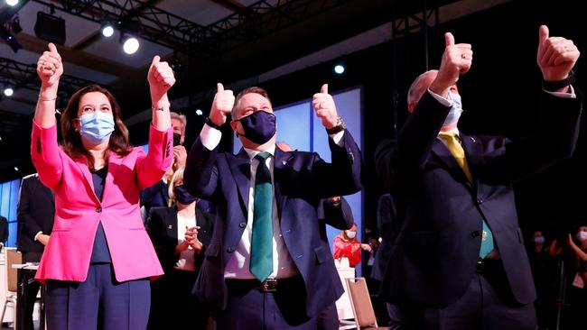 Queensland Premier Annastacia Palaszczuk, left, Brisbane mayor Adrian Schrinner and federal Sports Minister Richard Colbeck celebrate in Tokyo on Thursday. Picture: AFP