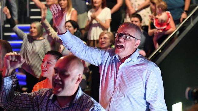 Prime Minister Scott Morrison and wife Jenny sing during an Easter Sunday service at his Horizon Church at Sutherland in Sydney in 2019.