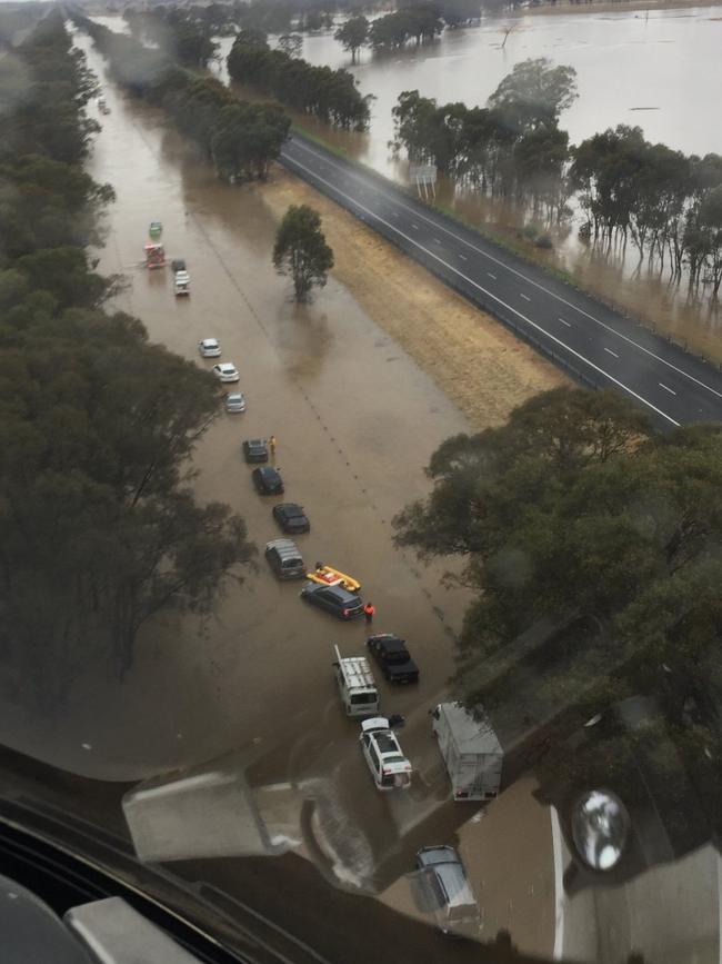 Flooding on the Hume Freeway yesterday left cars and trucks stranded. Picture: Victoria Police