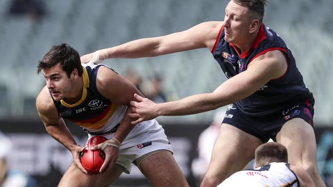 Adelaide’s Darcy Fogarty wins the ball under pressure from Norwood’s Sam Baulderstone in the first semi-final. Picture: SARAH REED