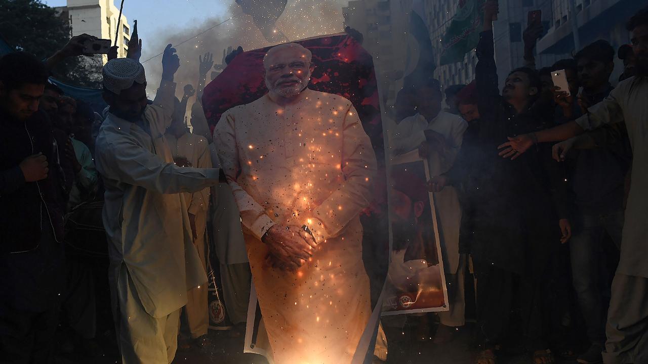 Pakistanis torch a poster of Indian Prime Minister Narendra Modi during an anti-Indian protest in Karachi. Picture: AFP