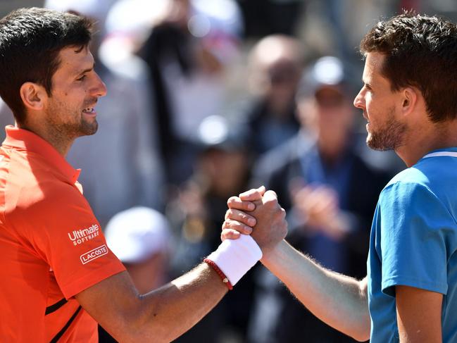 Novak Djokovic (left) and Dominic Thiem shake hands after their match. Picture: AFP