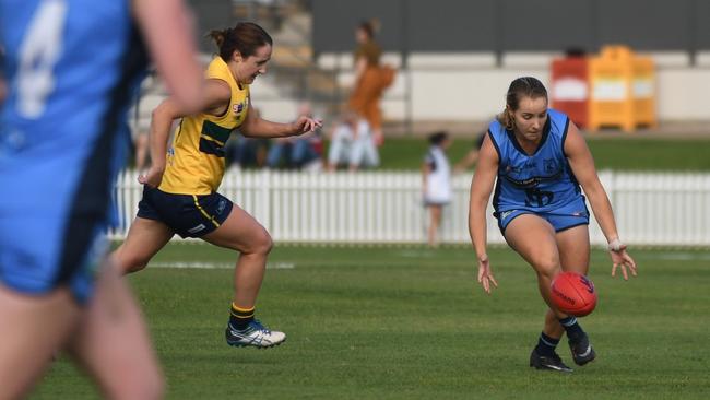 Sturt’s Lauren Lovell attempts to pick up the ball but is being chased by Woodville-West Torrens’ Shae Hart on Saturday. Picture: Peter Swan