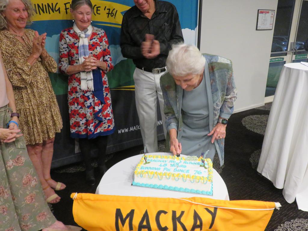 Life Member, Agnes Farmer cuts the 45th Anniversary cake supported by other Life Members and the sixty strong crowd at the Mackay Road Runners awards ceremony. Picture: Contributed