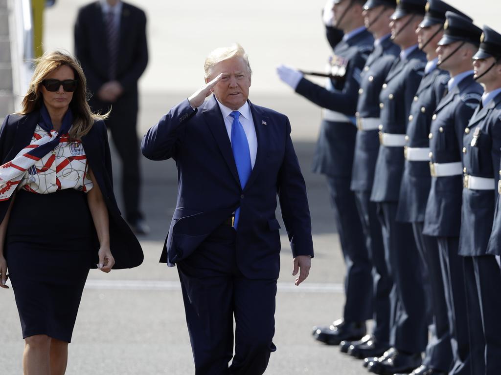 The President, pictured saluting an honour guard, will visit Buckingham Palace for a ceremonial welcome before meetings with royals and a state banquet on Monday night. Picture: AP Photo/Kirsty Wigglesworth