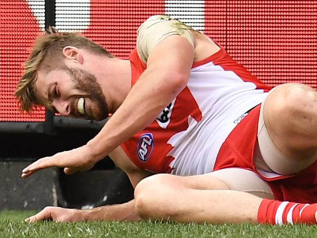 Alex Johnson of the Swans is seen after sustaining an injury during the Round 21 AFL match between the Melbourne Demons and the Sydney Swans at the MCG in Melbourne, Sunday, August 12, 2018. (AAP Image/Julian Smith) NO ARCHIVING, EDITORIAL USE ONLY