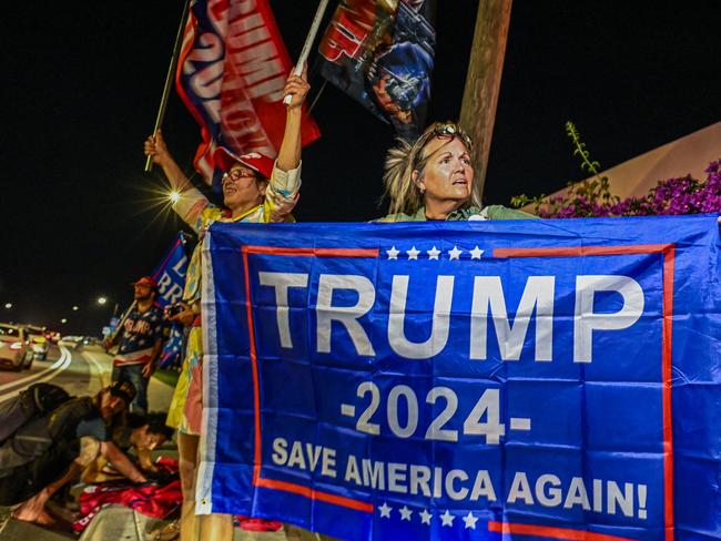 A Trump fan waves a flag at Mar-A-Lago in West Palm Beach, Florida. Picture: Giorgio Viera / AFP