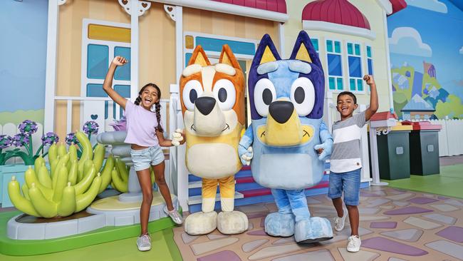 The first glimpse of Bluey's World Brisbane as fans eagerly await the opening next month. Pictured is Madeleine Evans, 10, and Joshua Evans, 7, with Bingo and Bluey.