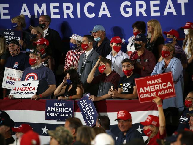 Supporters of President Donald Trump listen as he speaks at an airport hanger at a rally a day after he formally accepted his party’s nomination at the Republican National Convention. Picture: Getty