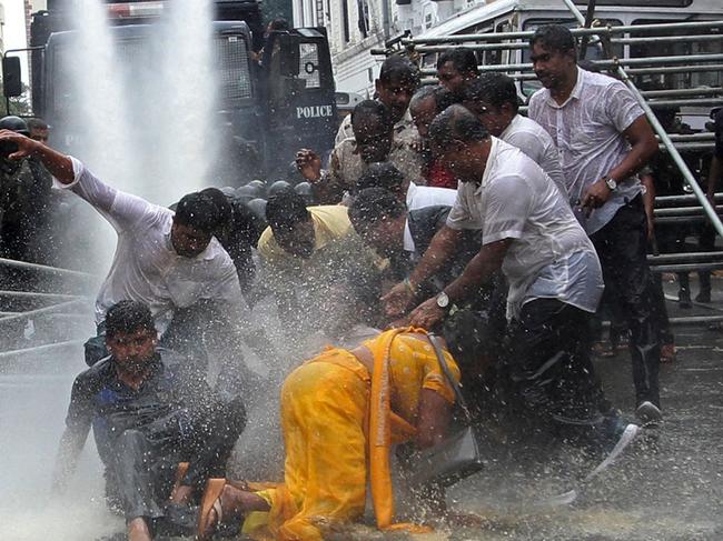 Police use water canon to disperse farmers taking part in an anti-government protest demanding the resignation of Sri Lanka's President Gotabaya Rajapaksa over the country's ongoing economic crisis in Colombo on July 6, 2022. (Photo by AFP)