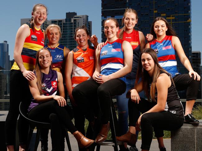 MELBOURNE, AUSTRALIA - OCTOBER 18: (L-R) Jessica Allan of the Crows, Stephanie Cain of the Dockers, Jordan Zanchetta of the Lions, Jodie Hicks of the Giants, Isabel Huntington of the Bulldogs, Eden Zanker of the Demons, Chloe Molloy of the Magpies and Monique Conti of the Bulldogs pose for a photograph during the 2017 NAB AFL Women's Draft at Docklands on October 18, 2017 in Melbourne, Australia. (Photo by Michael Willson/AFL Media/Getty Images)