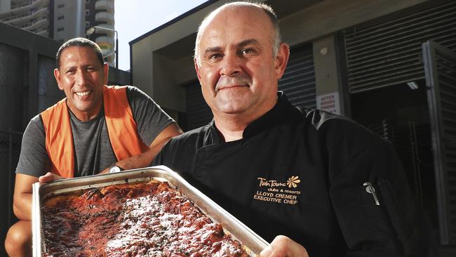 Twin Towns executive Chef Lloyd Cremer delivering a tray of lasagne to Vibe Church senior pastor David Nahi.