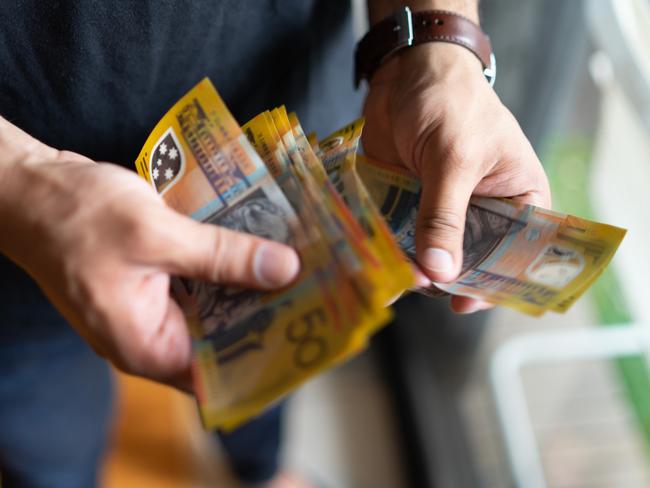 young male counting his savings