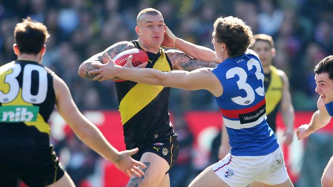 Richmond star Dustin Martin shrugs aside Aaron Naughton. Picture: Michael Klein