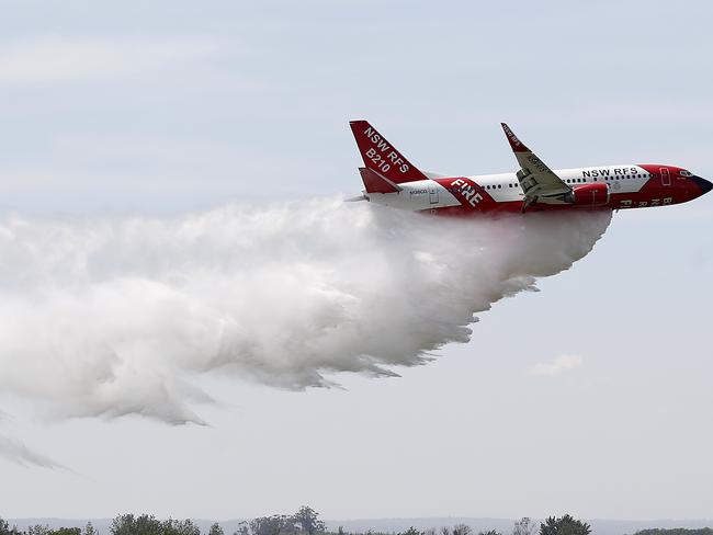 SYDNEY, AUSTRALIA - OCTOBER 23: The RFS Marie Bashir 737 Large Air Tanker (LAT) drops water during a demonstration flight at RAAF Base Richmond on October 23, 2020 in Sydney, Australia. The NSW RFS aerial firefighting fleet is the largest of any fire agency in Australia. (Photo by Ryan Pierse/Getty Images)