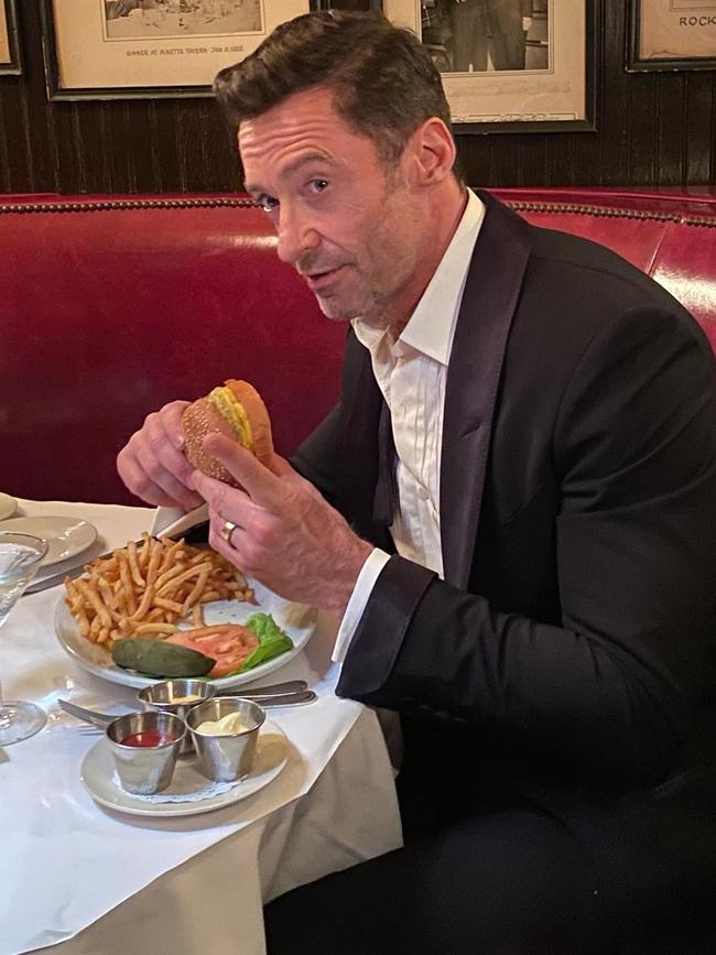 Hugh Jackman spotted gobbling down a cheeseburger and fries before beginning his transformation into Wolverine. Picture: Supplied