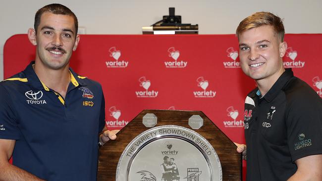 Crows co-Captain Taylor Walker and Port Adelaide co-captain Ollie Wines at Variety with the Showdown Shield. Picture SARAH REED