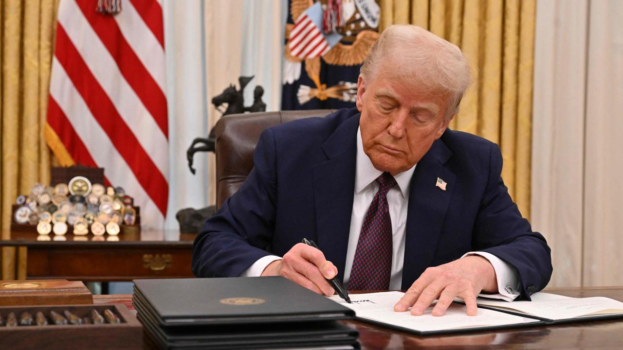 US President Donald Trump signs an executive order in the Oval Office of the White House. Picture: Roberto Schmidt/AFP