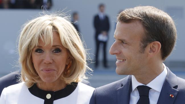 French President Emmanuel Macron and his wife Brigitte Macron leave the tribune after the traditional Bastille Day military parade on the Champs-Elysees avenue in Paris earlier today. Photo: AFP