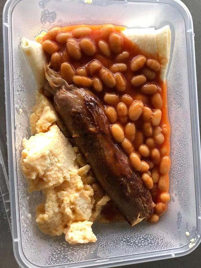 A typical breakfast, prepared by Australian Defence Force personnel, is baked beans, sausage and scrambled egg. Picture: Supplied.