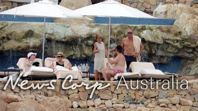 Julie Bishop and David Panton chat today on beach ahead of Karl Stefanovic’s wedding. Picture: Nathan Edwards